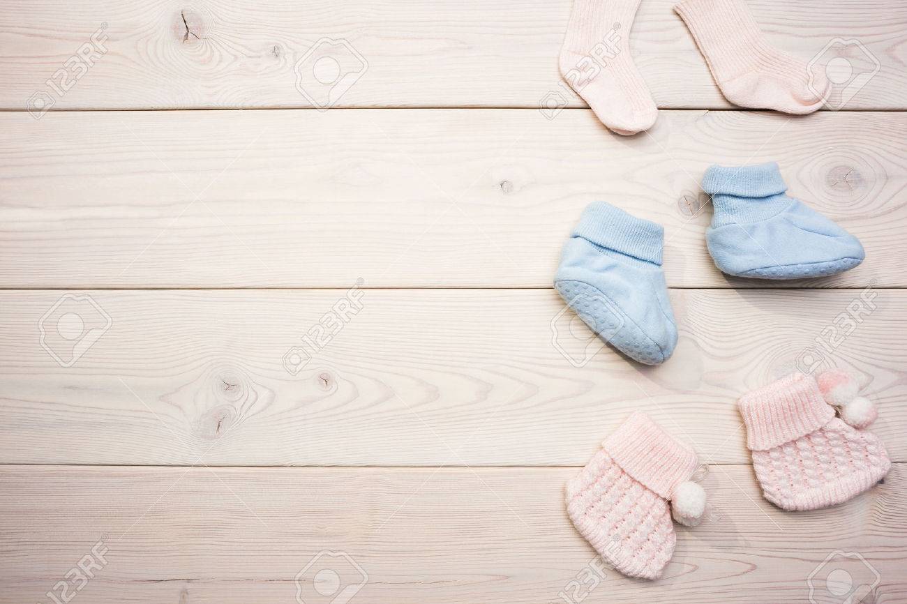 Cute baby girl and baby boy socks on blank wooden surface. Mock up - 59651805 Cute baby girl and baby boy socks on blank wooden surface. Mock up - 59651805