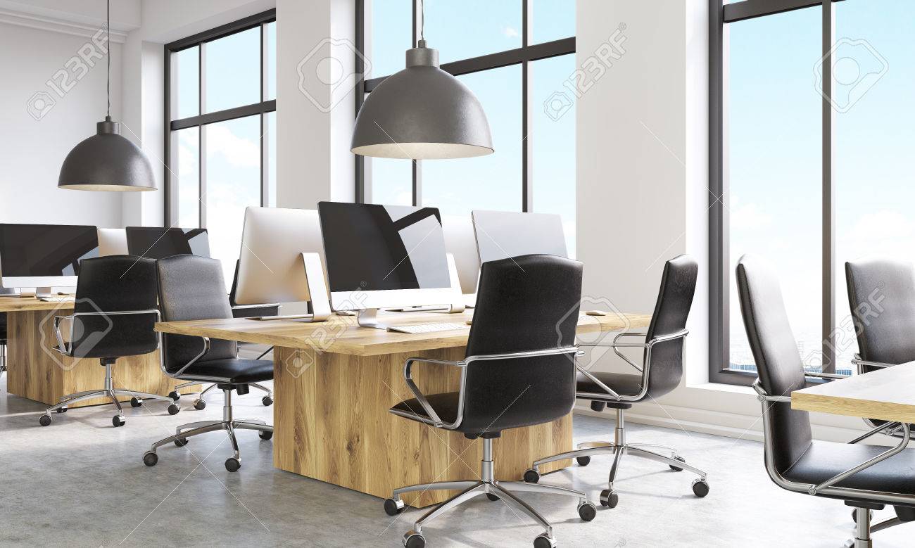 Side View Of Coworking Office Interior With Computer Monitors On Wooden Desks Parquet Flooring Side View Of Coworking Office Interior With Computer Monitors On Wooden Desks Parquet Flooring