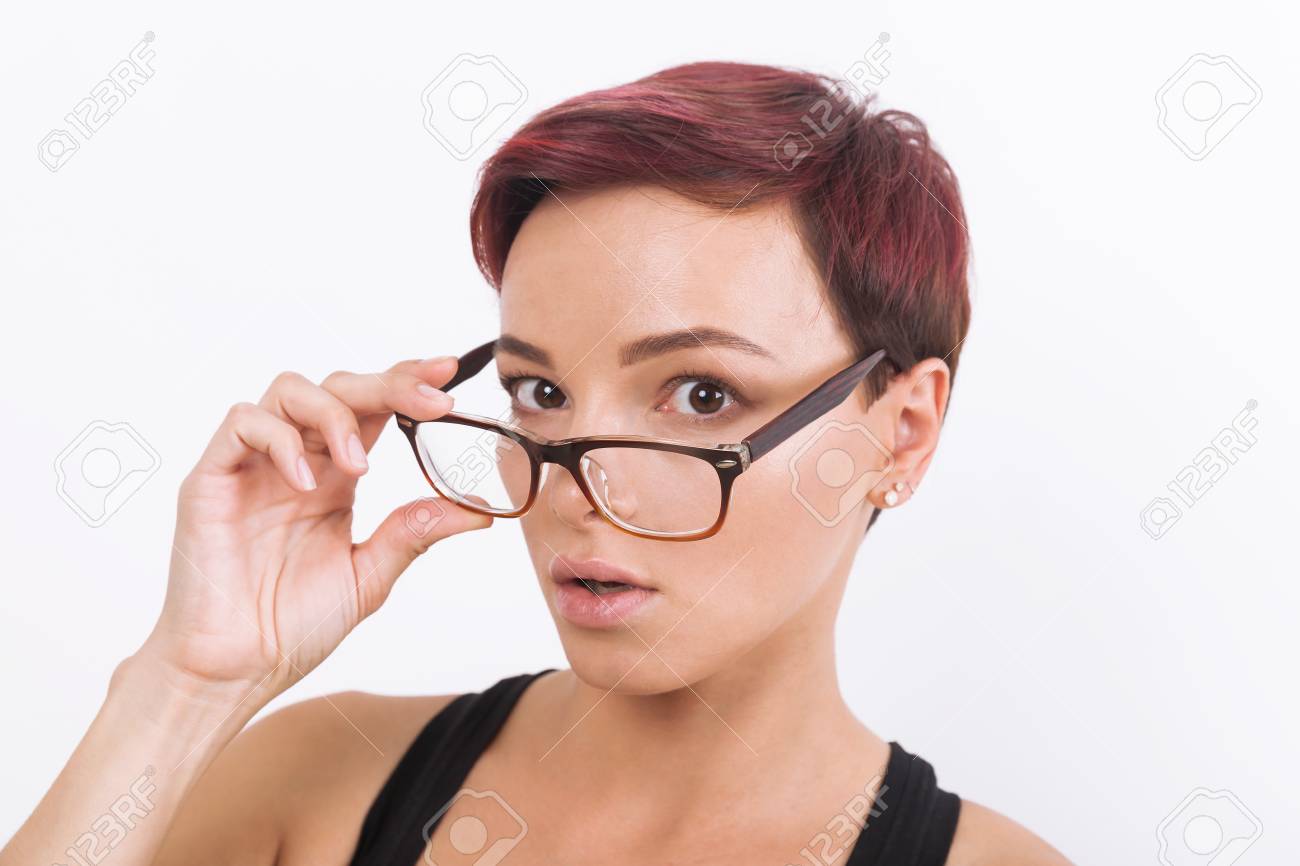 Surprised Young Lady With Short Hair Dyed Red And In Glasses
