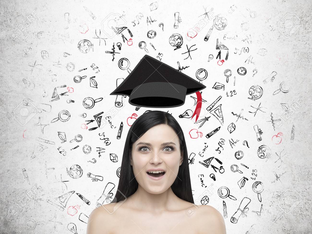 close up of amazed girl with graduation hat floating above her