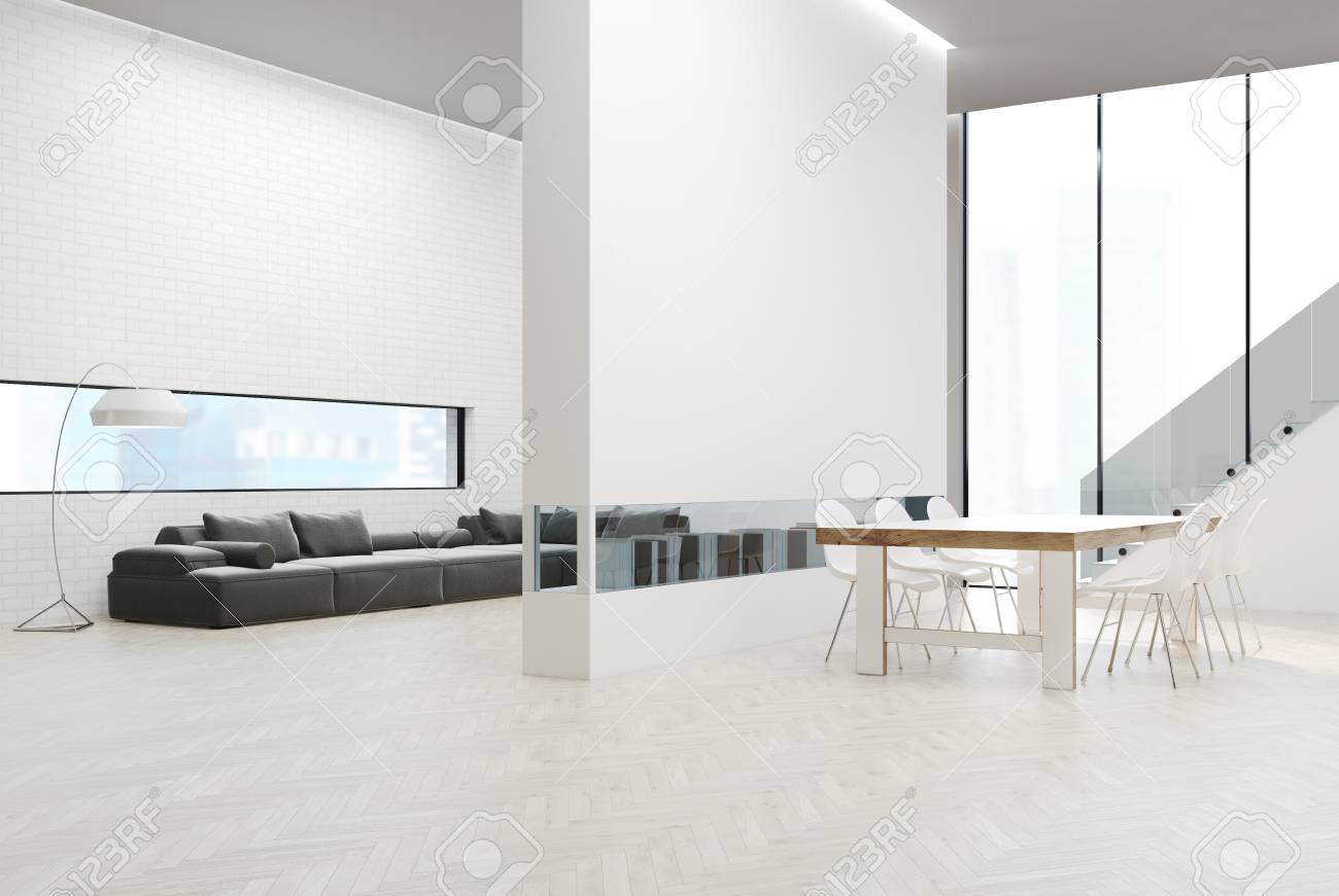 Mur De Briques Blanches Avec Un Canapé Gris Et Des Poufs Une Bibliothèque Dans Un Mur Blanc Une Table De Salle à Manger Un Escalier Et Une Fenêtre