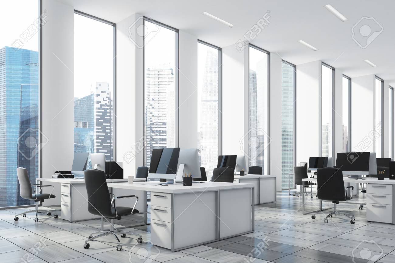 white open office with narrow tall windows white computer tables