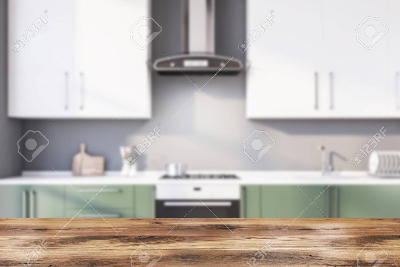 white kitchen cabinets with green countertops table for your product in blurry kitchen with gray walls green white kitchen cabinets with green countertops table for your product in blurry kitchen with gray walls green