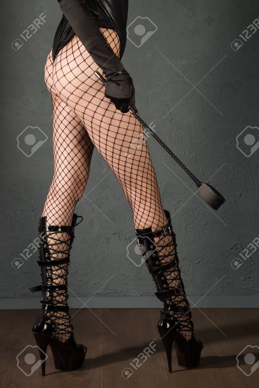iskov sergeyBeautiful Sexy Dominant Vamp Mistress Dominatrix Bdsm Woman Model With Spank And High Heels Posing Back , Sex Shop Concept. picture