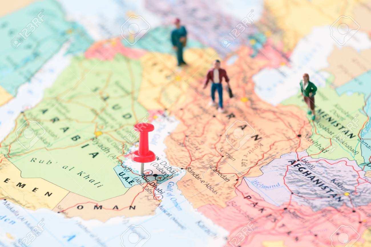 pinned on map of dubai in uae and miniature travelers stock photo pinned map