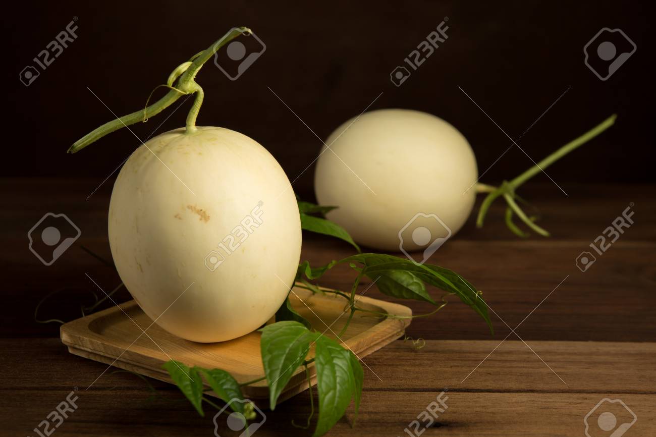 Yellow cantaloupe melon on the wooden background. - 60202030 Yellow cantaloupe melon on the wooden background. - 60202030