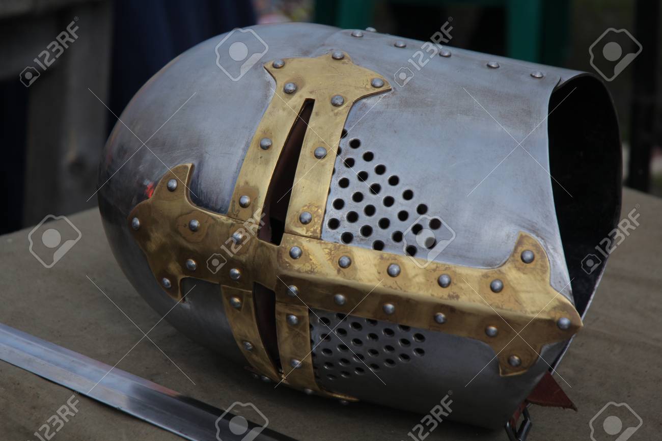 Part of a knight\u0027s medieval suit of armor. Helmet and sword beside..