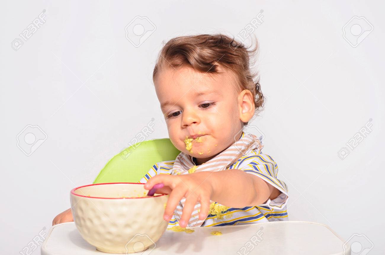 赤ちゃんスプーン 汚い汚いと取得を食べる幼児 幼児の朝食としてオートミールを持つ食べ物 の写真素材 画像素材 Image