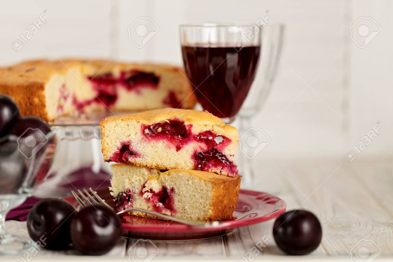 Homemade Plum Cake On A Glass Stand And Red Wine Selective Focus