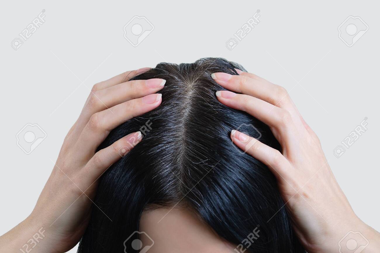 Head of a caucasian woman with black gray hair. Fingers in hair. - 135875553 Head of a caucasian woman with black gray hair. Fingers in hair. - 135875553