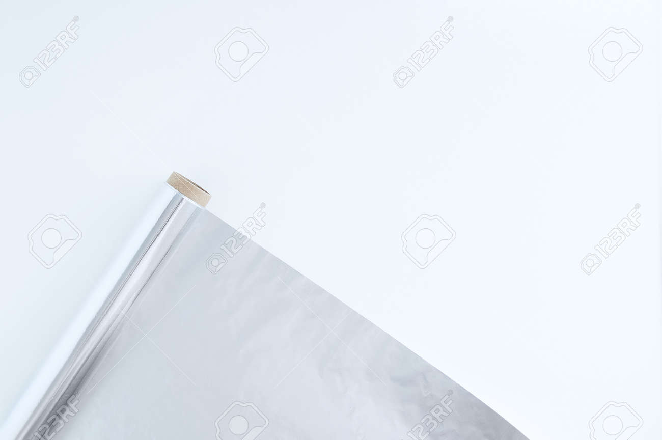 A roll of foil for baking. White background. Kitchen utensils. - 166501123 A roll of foil for baking. White background. Kitchen utensils. - 166501123