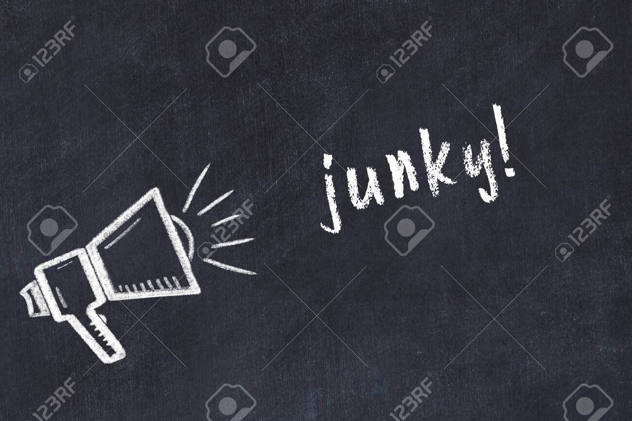 Chalk drawing of loudspeaker and handwritten inscription junky on black desk - 148598856 Chalk drawing of loudspeaker and handwritten inscription junky on black desk - 148598856