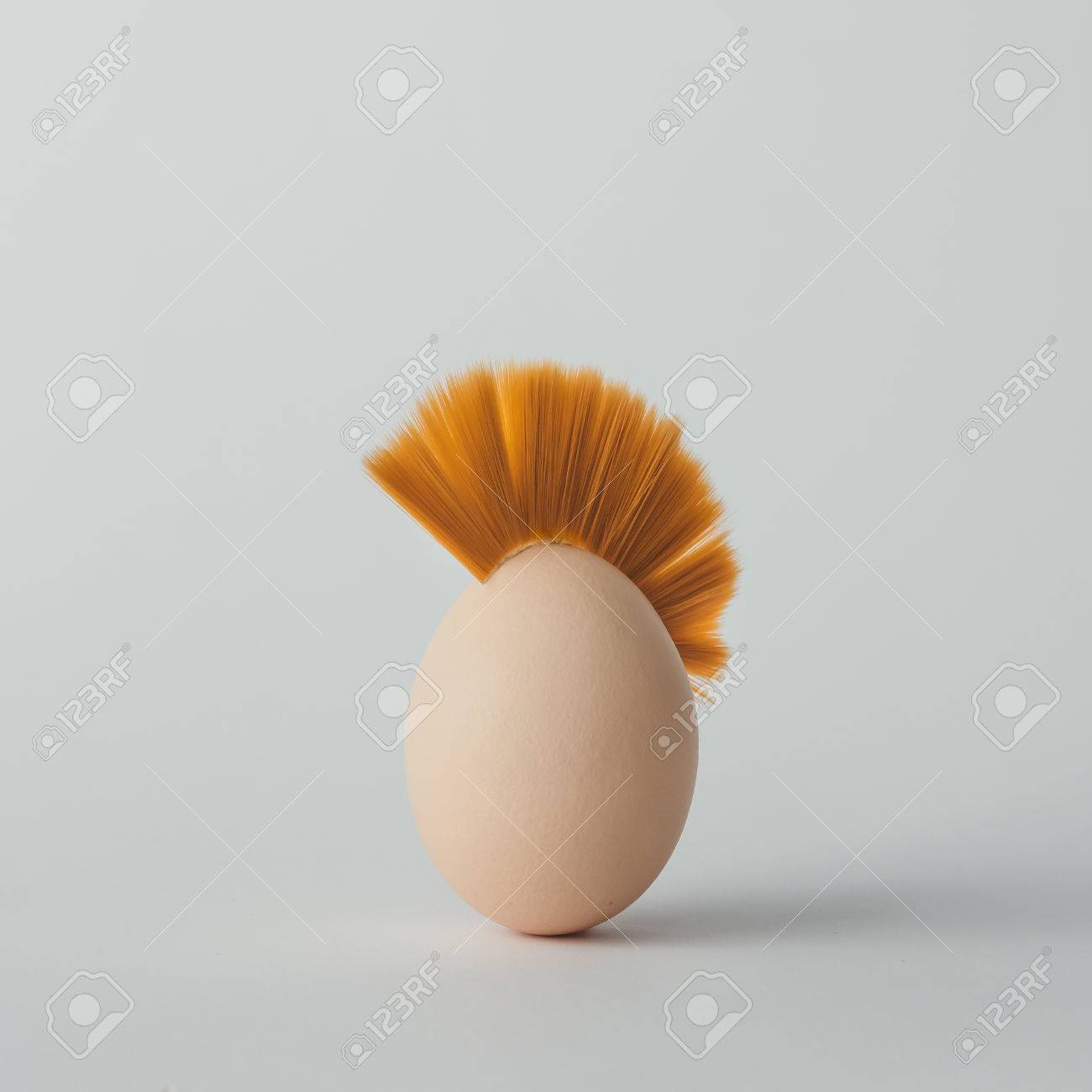 Easter egg with mohawk hair. Flat lay. Minimal concept. - 73356182 Easter egg with mohawk hair. Flat lay. Minimal concept. - 73356182