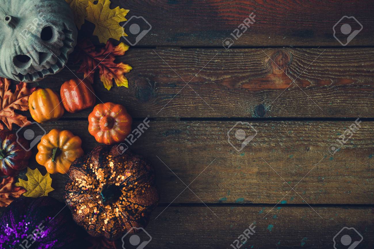 creative autumn halloween layout with various leaves and pumpkins on