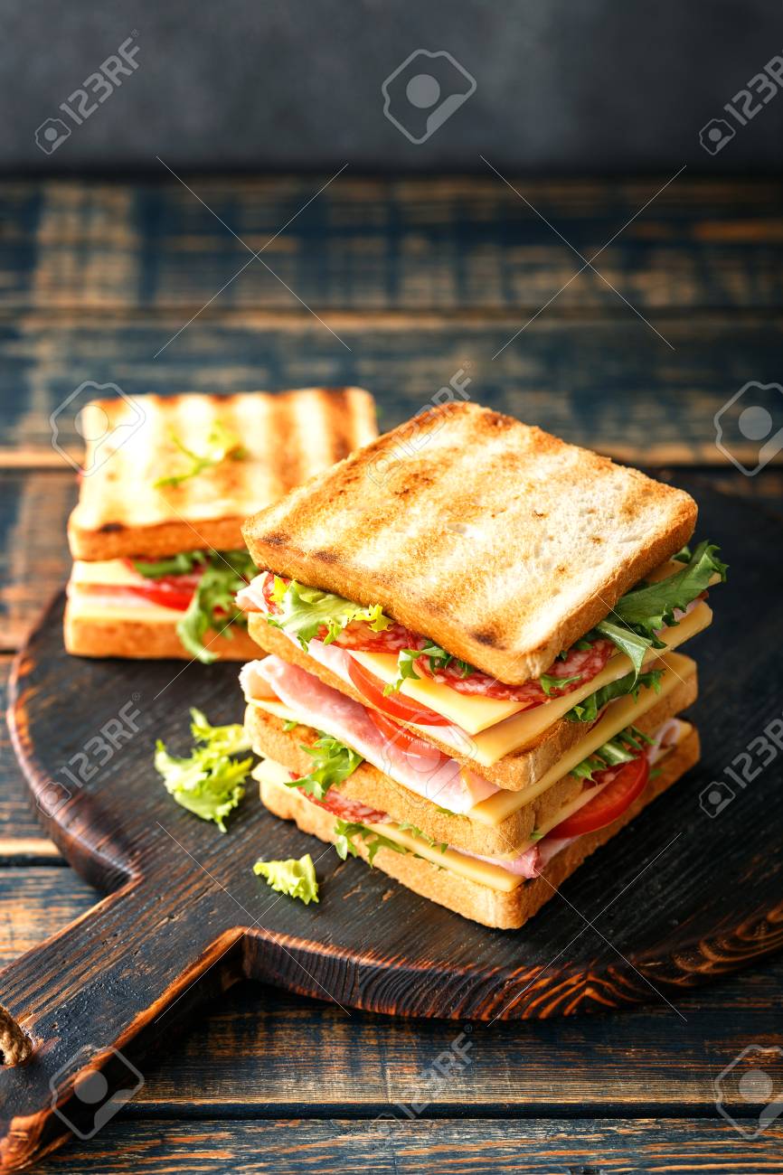 sandwiches with grilled toast ham salami cheese tomatoes and lettuce - 113696987 sandwiches with grilled toast ham salami cheese tomatoes and lettuce - 113696987