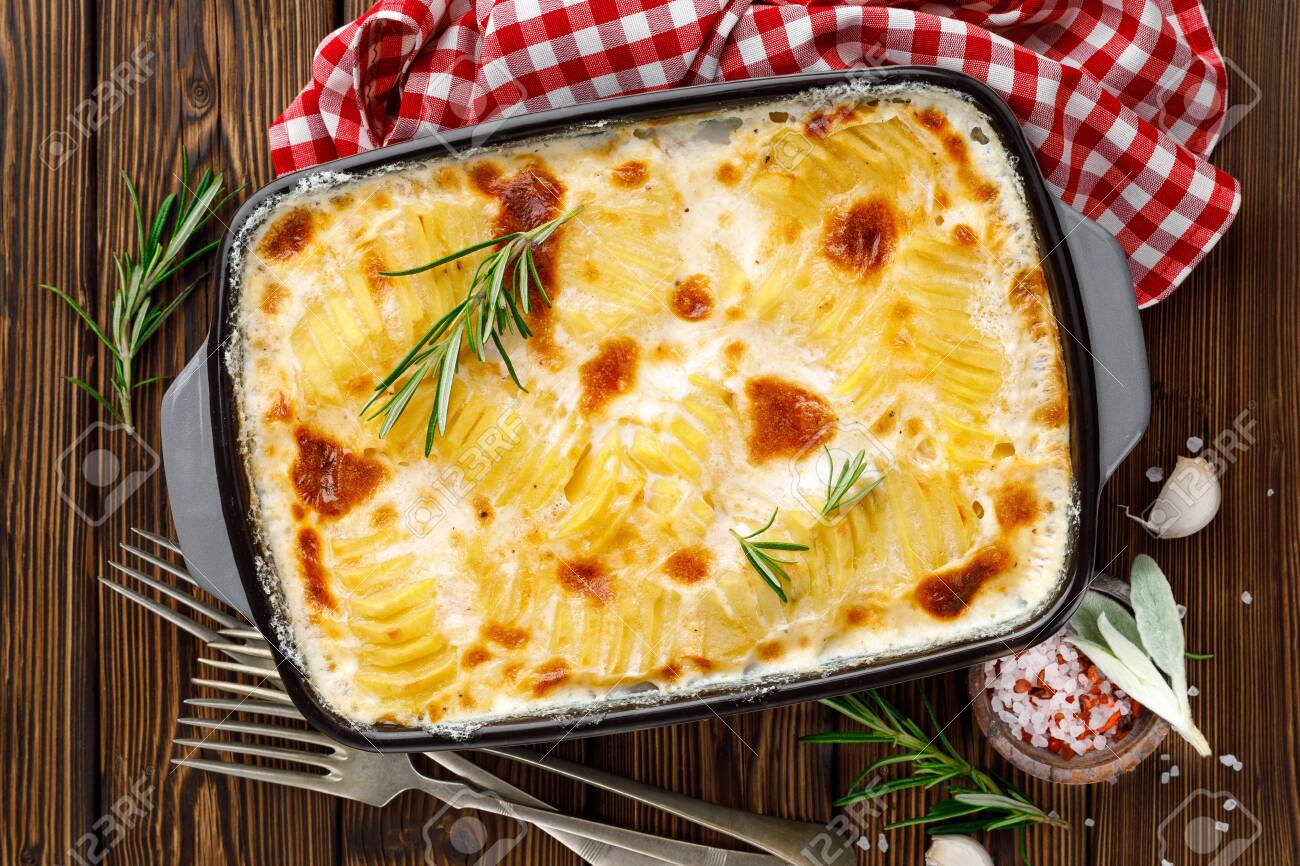 Potato gratin. Baked potato with cream, cheese and garlic - 129759846 Potato gratin. Baked potato with cream, cheese and garlic - 129759846