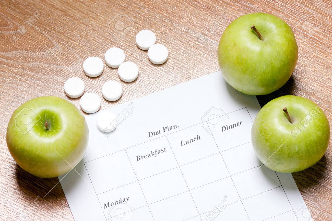 diet Plan. diet plan and apple lying on a wooden surface - 26117347 diet Plan. diet plan and apple lying on a wooden surface - 26117347