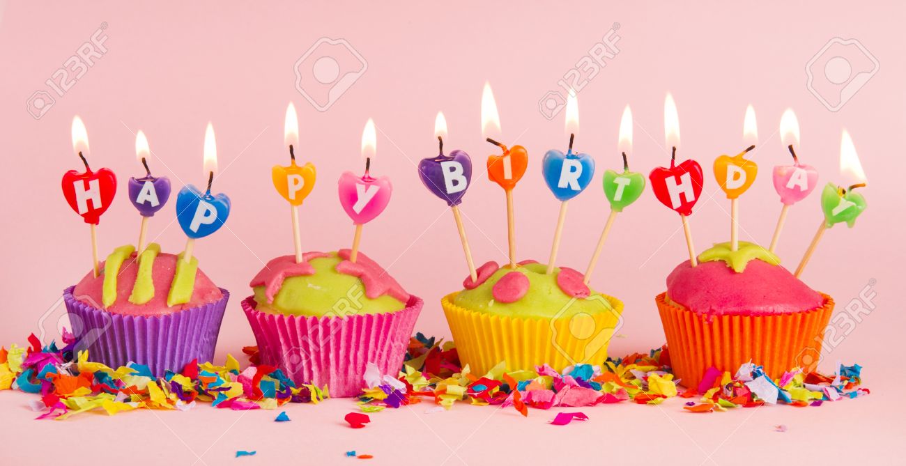 cup cakes with burning happy birthday candles stock photo picture