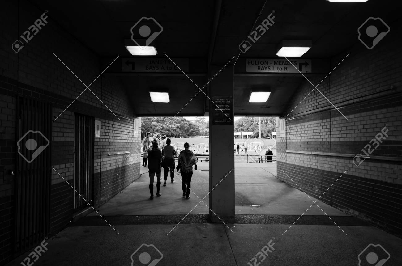 Passageway To Sports Oval With Silhouettes Of Walking People