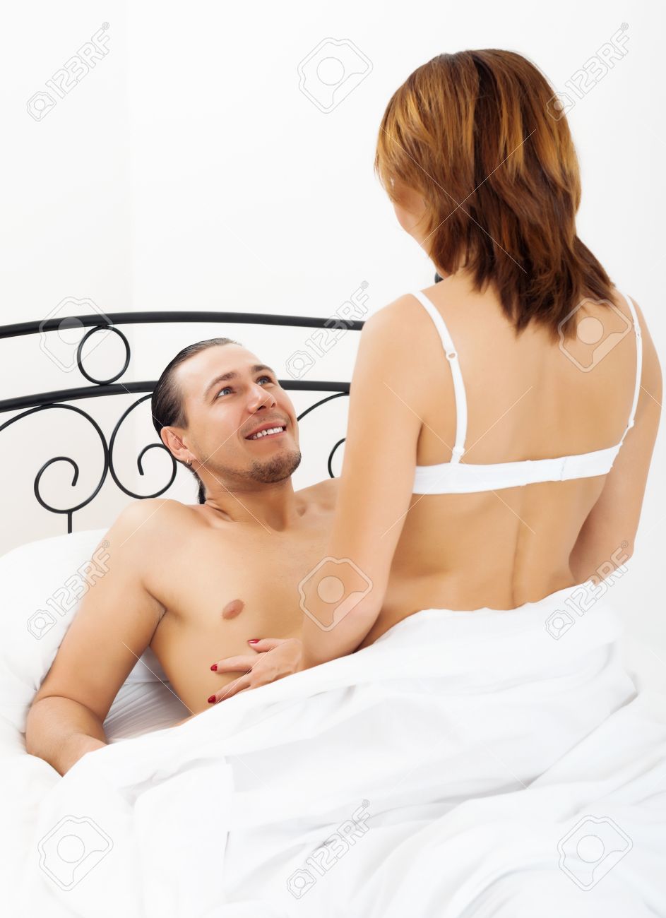 Middle-aged Man And Woman Having Sex On White Sheet In Bed Stock Photo, Picture and Royalty Free Image