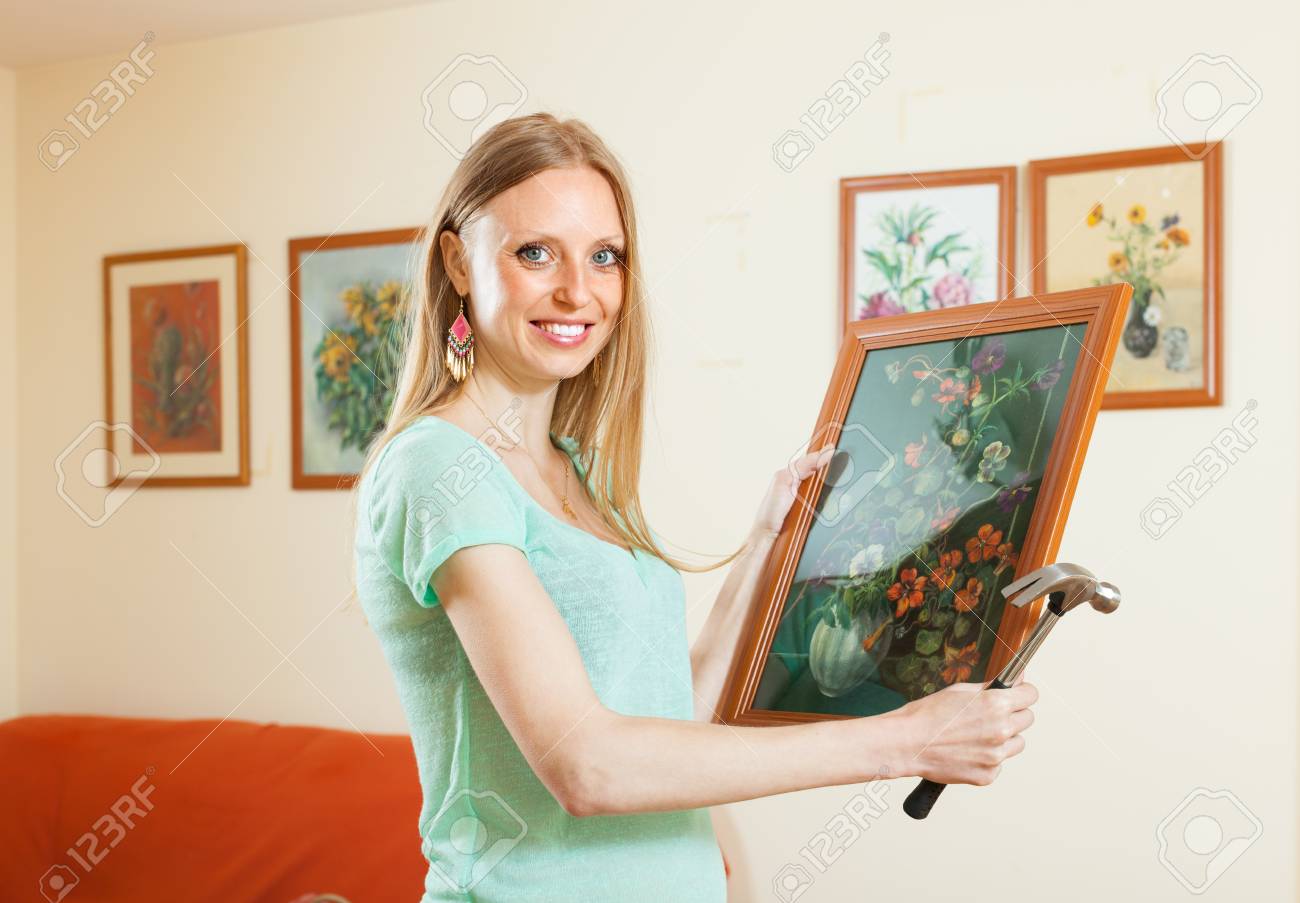 Feliz Nina Colgar Cuadros De Arte En La Pared En Casa Fotos