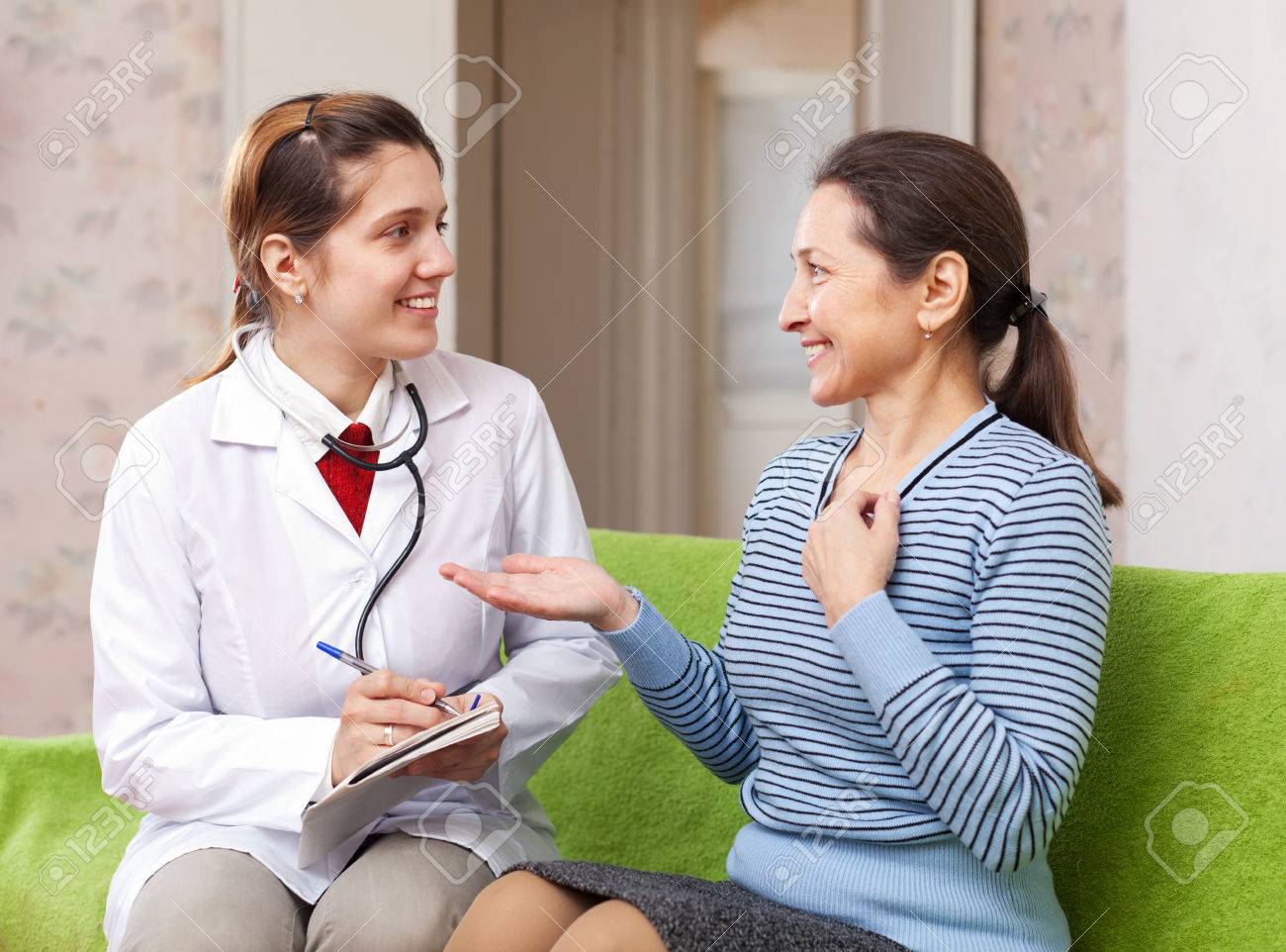 Happy doctor talks mature patient at medical hospital - 43507630 Happy doctor talks mature patient at medical hospital - 43507630