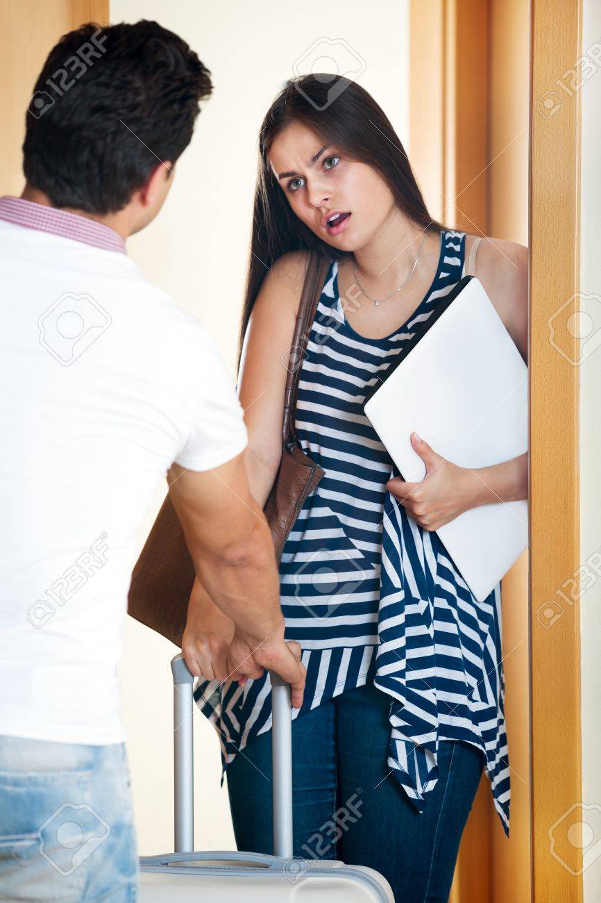 Frustrated Young Man Watching Wife photo