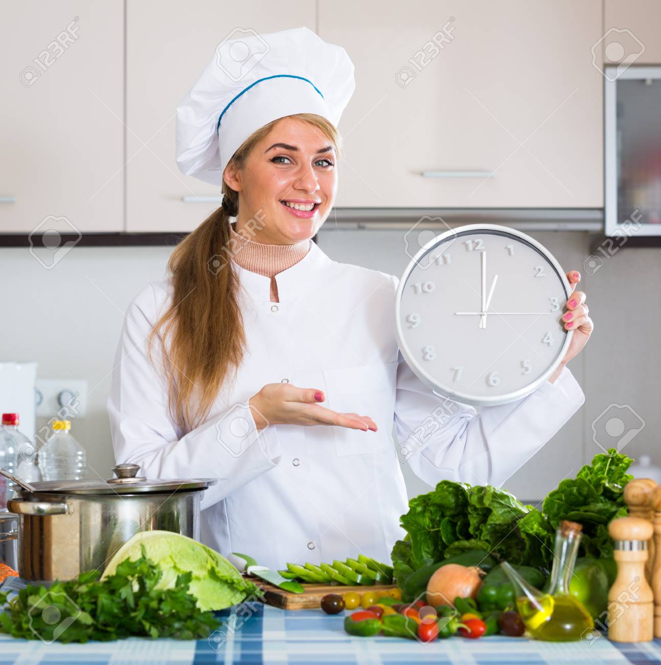 Professional Chef With Vegetables And Clock At Kitchen Table Stock
