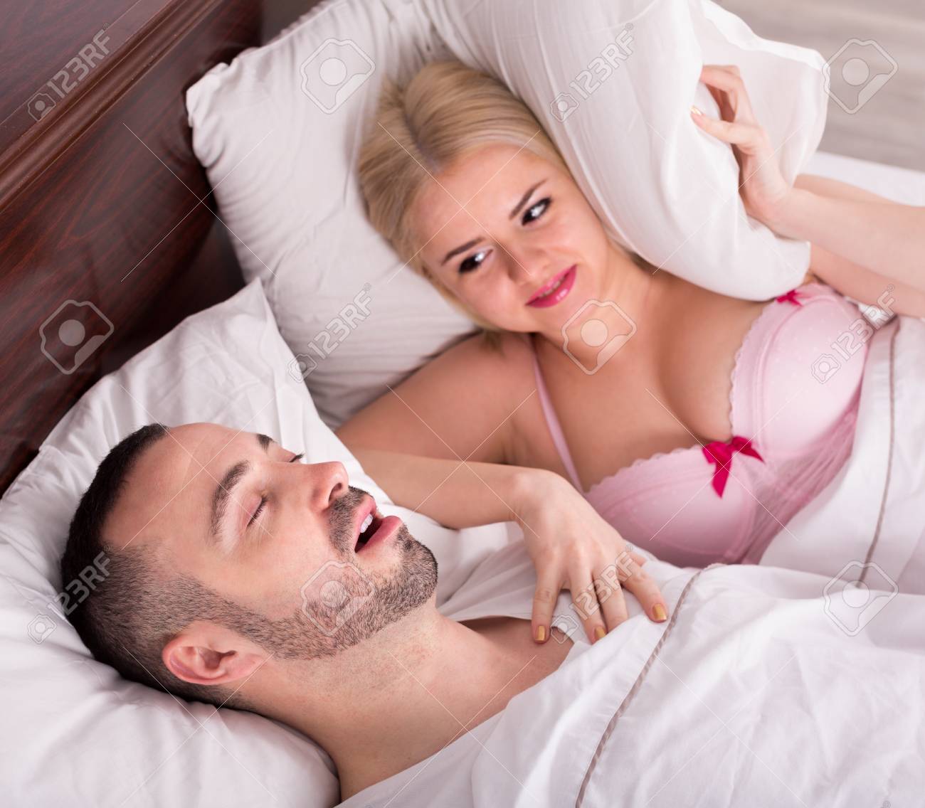 Unhappy Blond Wife Disturbed With Husband Snoring In Sleep In