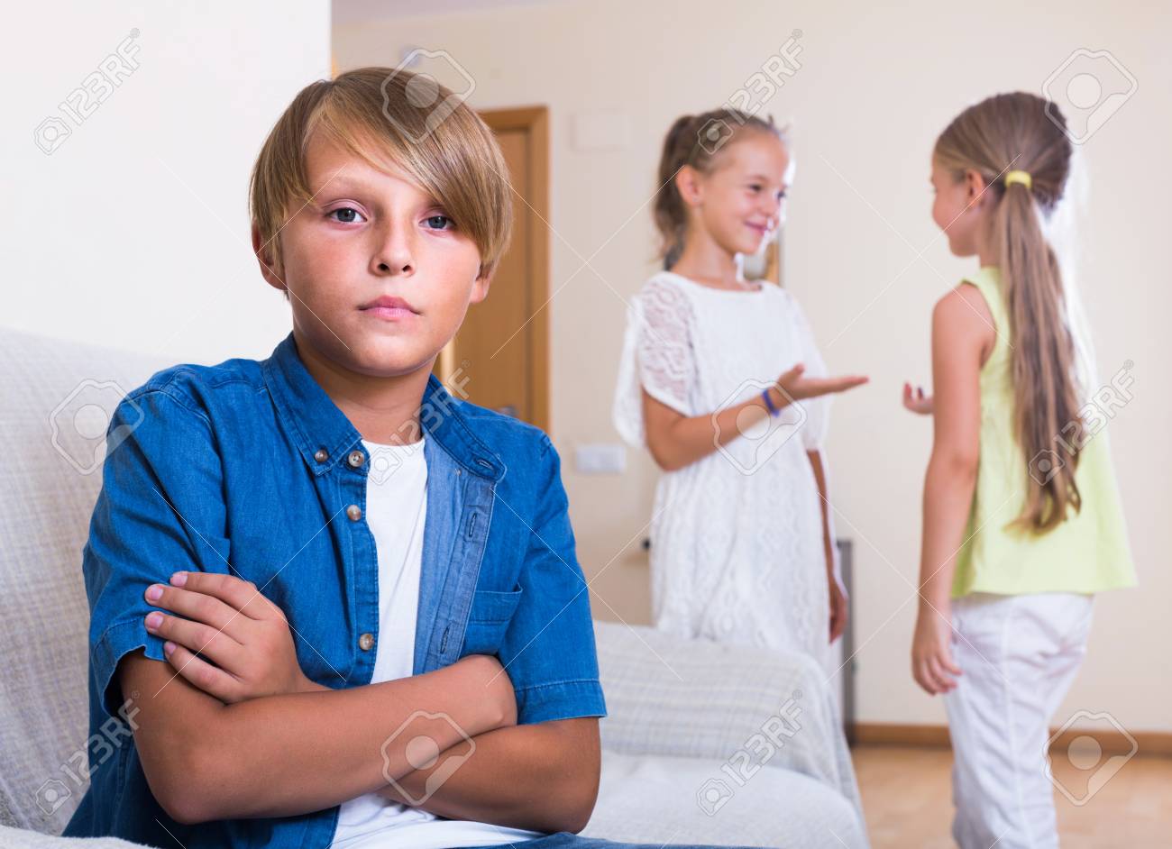 Two Little Spanish Girls Talking And Sulky Boy Sitting Separately Stock Photo Picture And Royalty Free Image Image 61280767