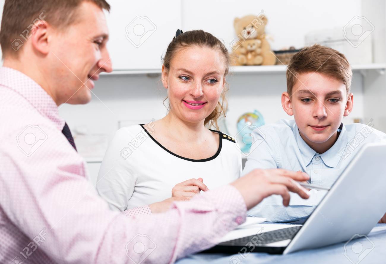 smiling middle aged mother and son signing agreement papers at