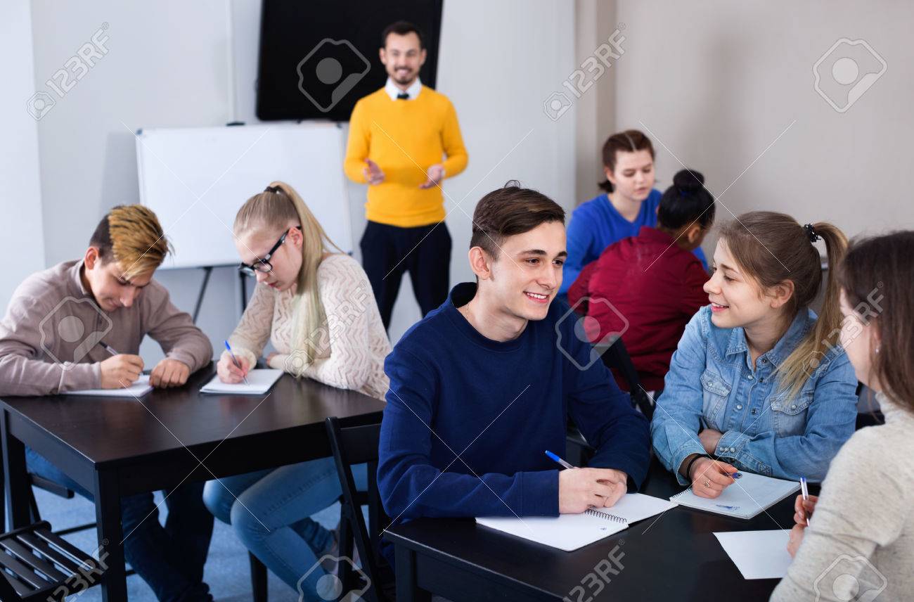Diligent Glad Smiling Fellow Students Having Group Work Tasks During School  Day Stock Photo, Picture and Royalty Free Image. Image 84754630., image size:1300x856