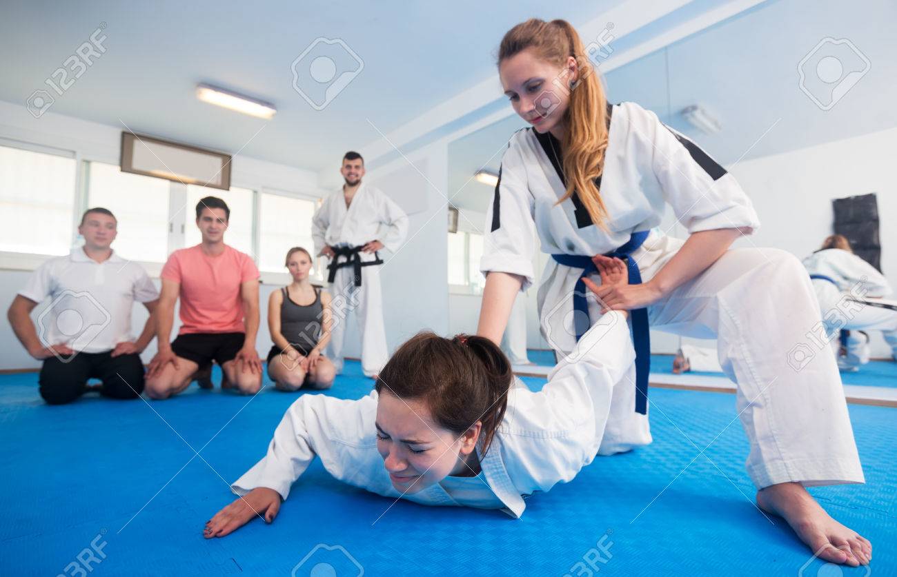 Young Female Coach Showing Painful Hold To Adults In Taekwondo Stock Photo Picture And Royalty Free Image Image