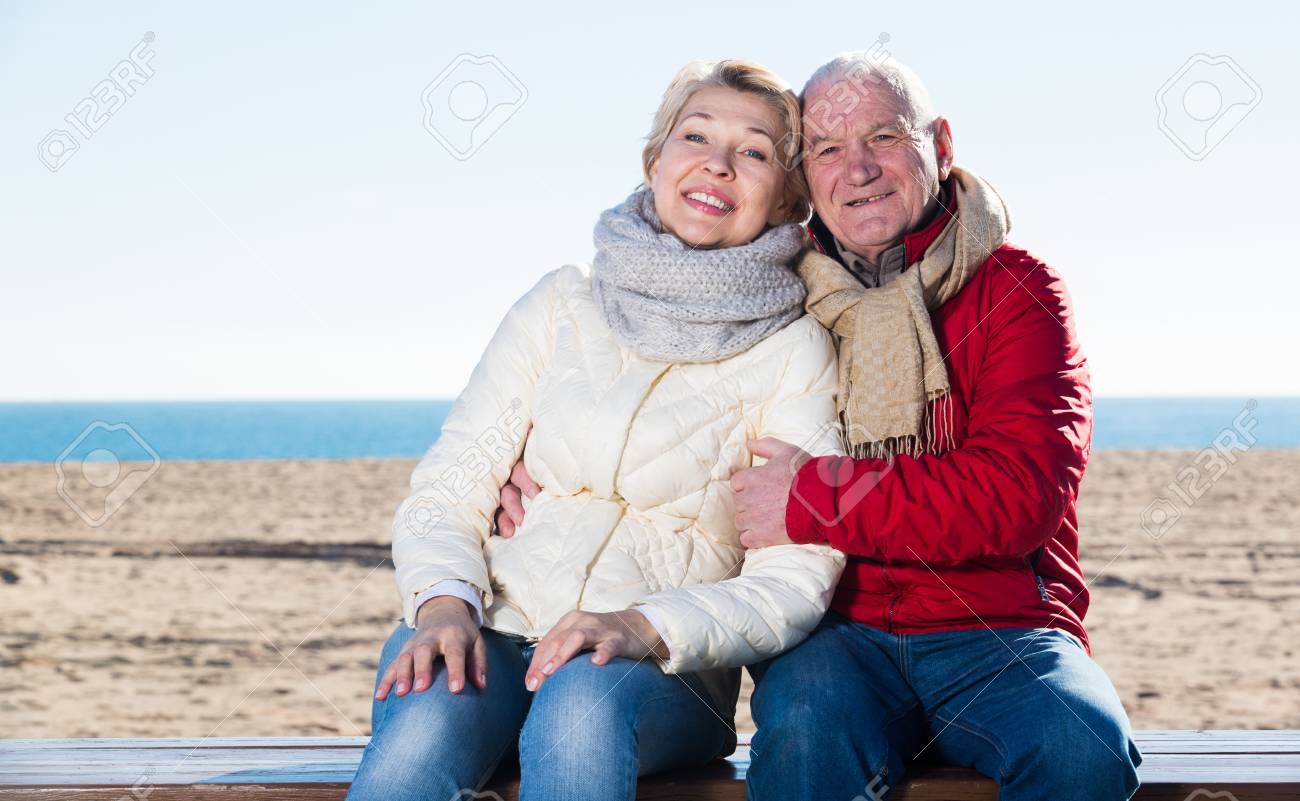 ベンチに座って海辺で抱き合うシニアカップル の写真素材 画像素材 Image