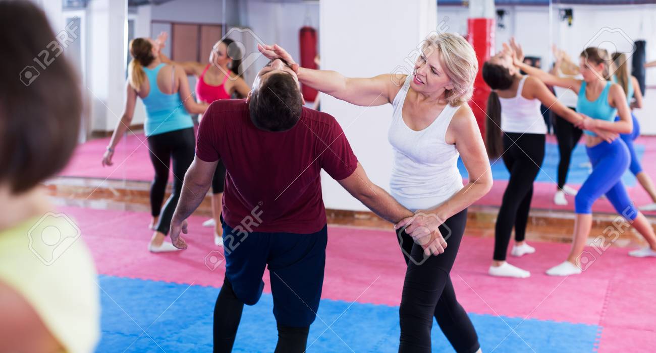 Mature Woman Is Doing Self Defence Moves With Trainer In Sporty Stock Photo Picture And Royalty Free Image Image