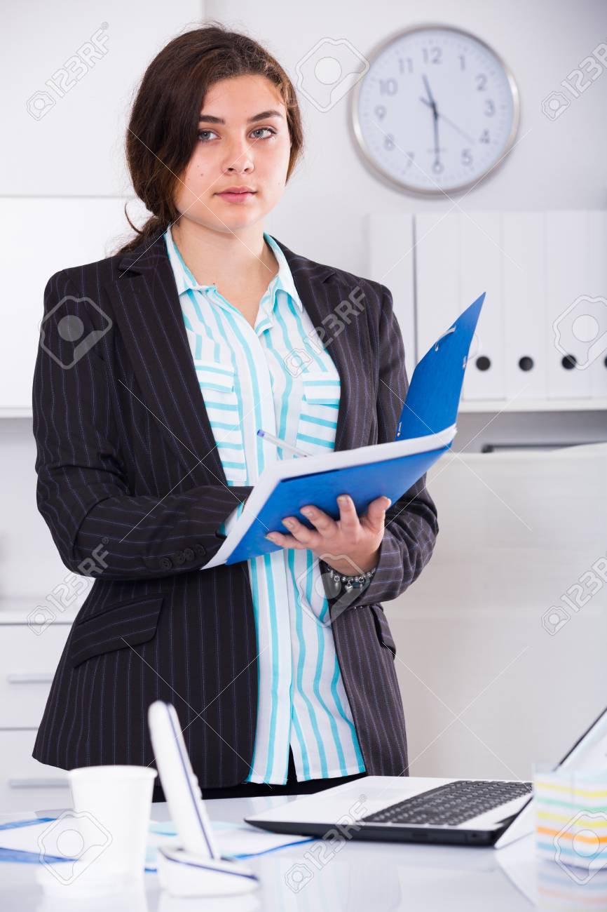 office worker woman is signing agreement papers of financial stock