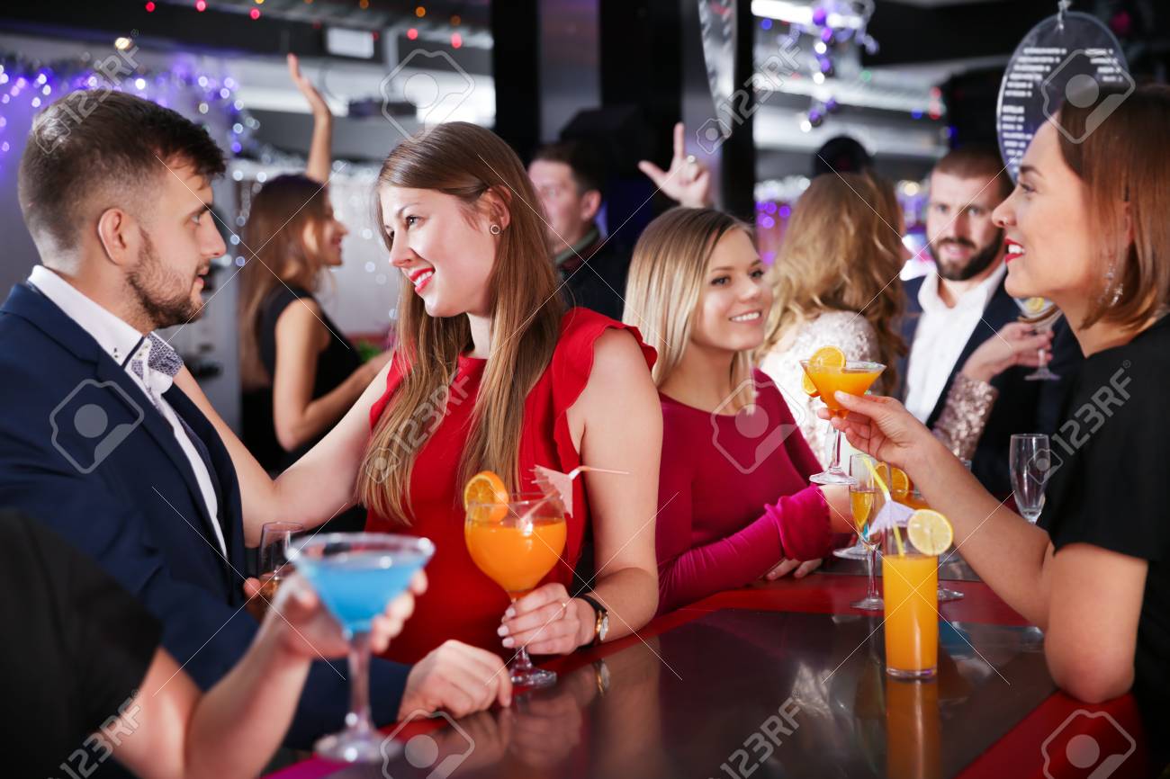 Attractive Girl Flirting With Handsome Man On Cocktail Party At Bar Stock  Photo, Picture and Royalty Free Image. Image 97385103., image size:1300x866