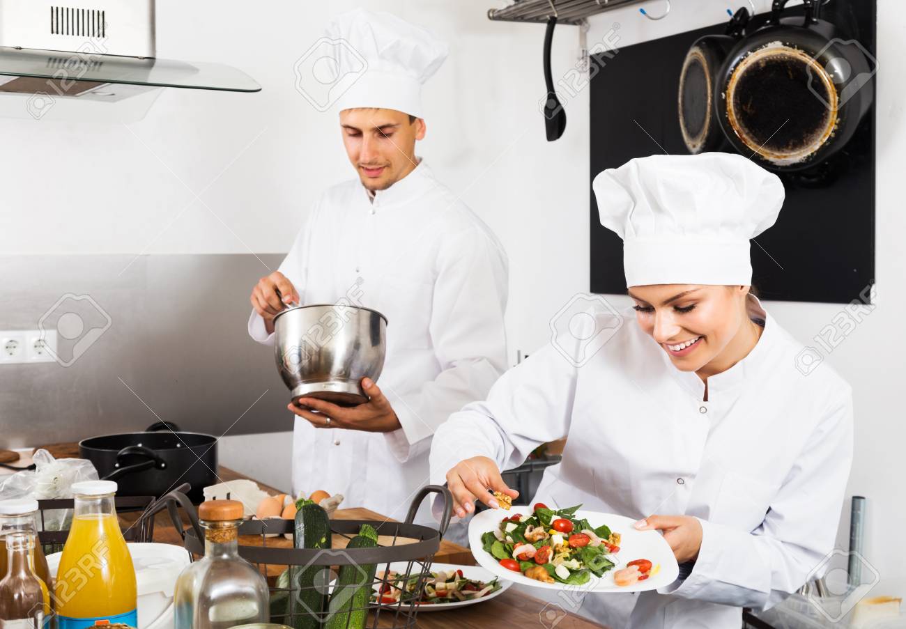 Two Happy Young Man And Woman Chefs Cooking Food At Restaurant S Stock Photo Picture And Royalty Free Image Image 116494145