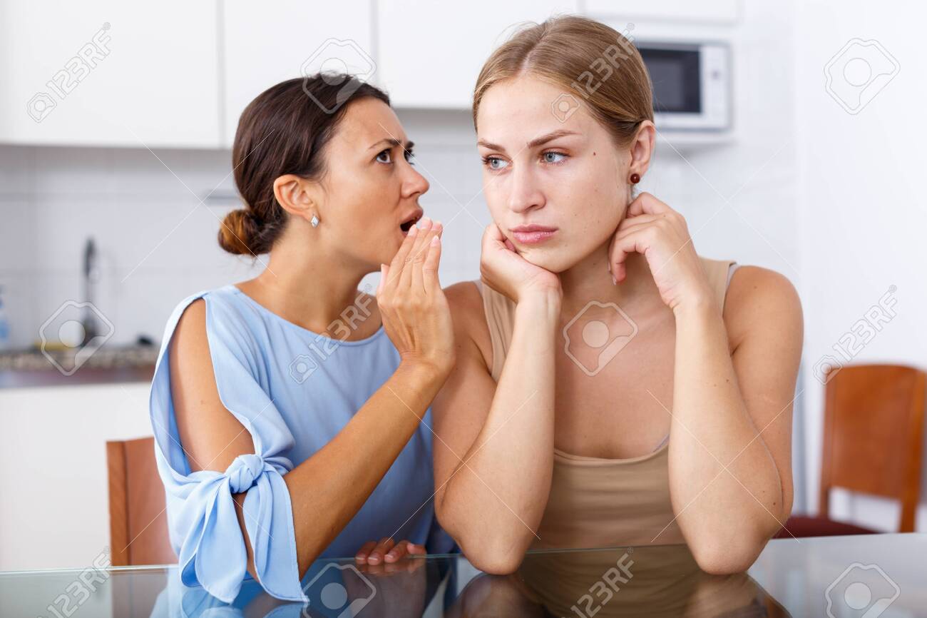 Upset Young Women Friends Whispers In The Ear And Talking At Stock Photo Picture And Royalty Free Image Image 127519124 upset young women friends whispers in the ear and talking at stock photo picture and royalty free image image 127519124