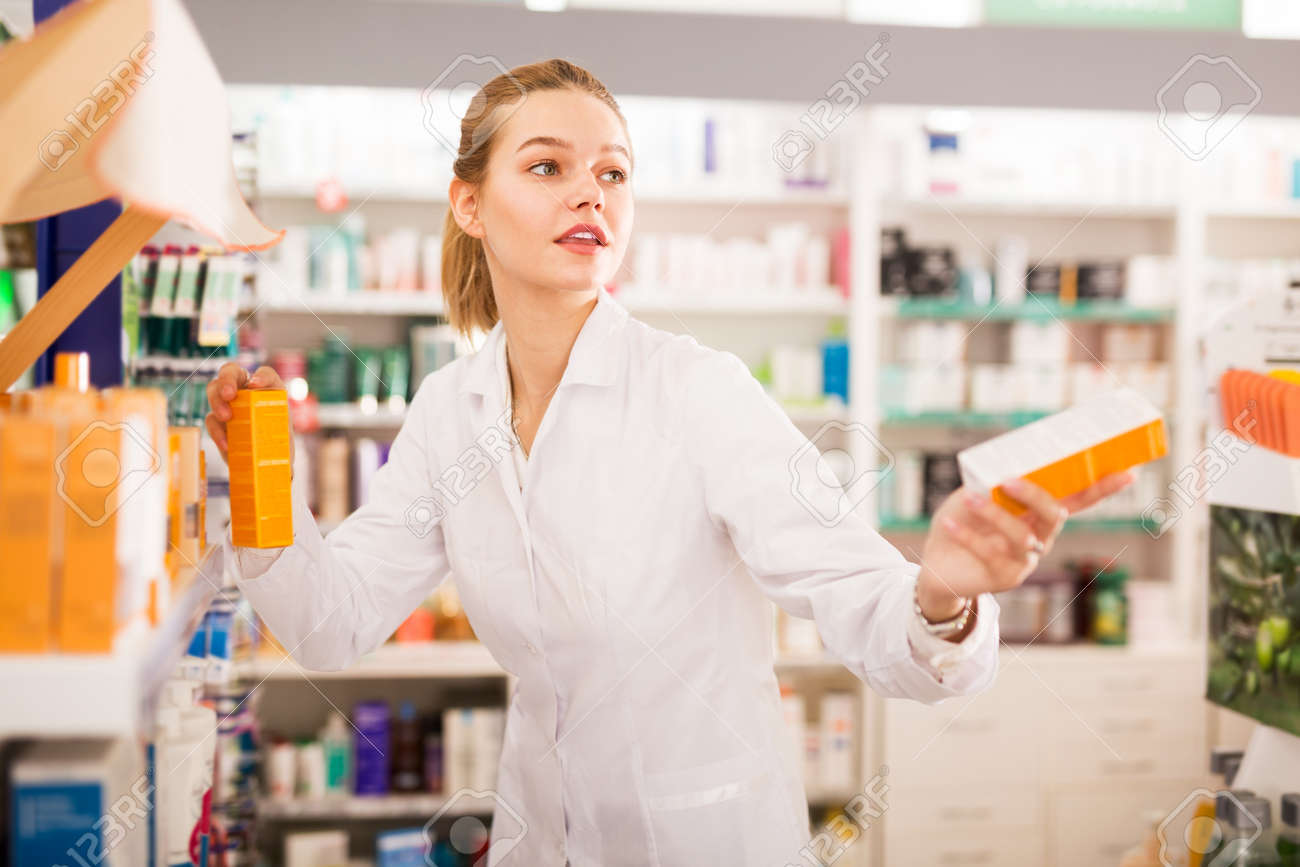 Pharmacist offering medicine in pharmacy - 167528675 Pharmacist offering medicine in pharmacy - 167528675