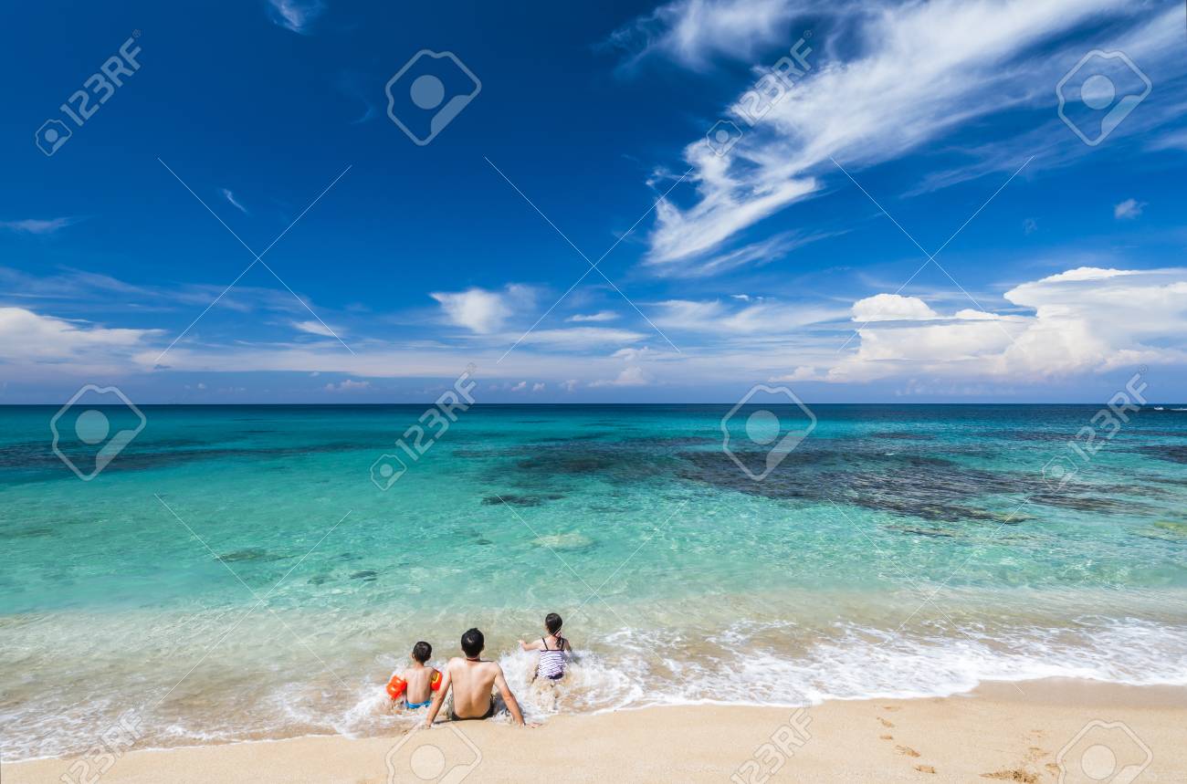 family with kids sitting on beach - 93918796 family with kids sitting on beach - 93918796