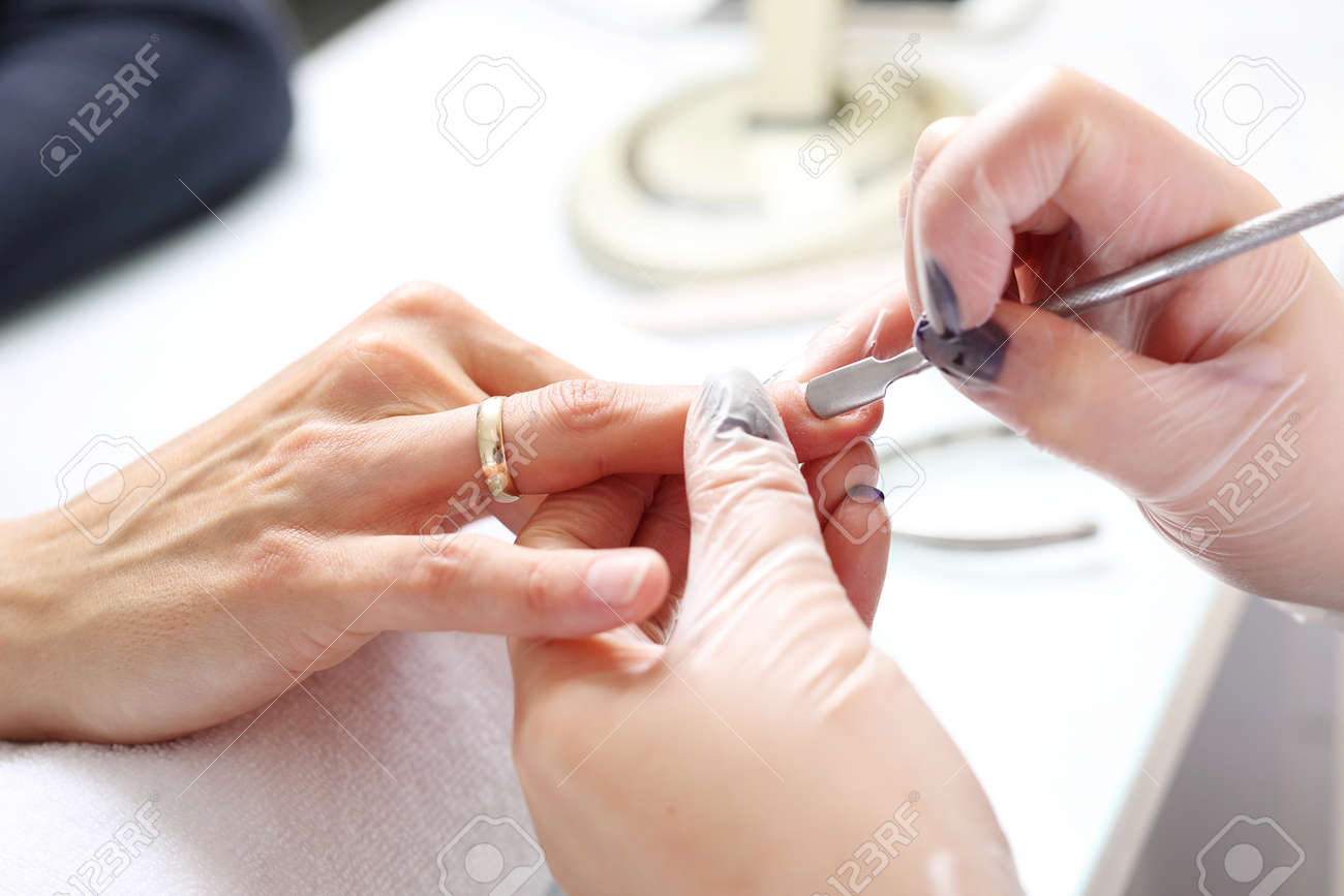 Hands beautifying treatment, woman in a beauty salon on a manicure procedure. - 137173401 Hands beautifying treatment, woman in a beauty salon on a manicure procedure. - 137173401