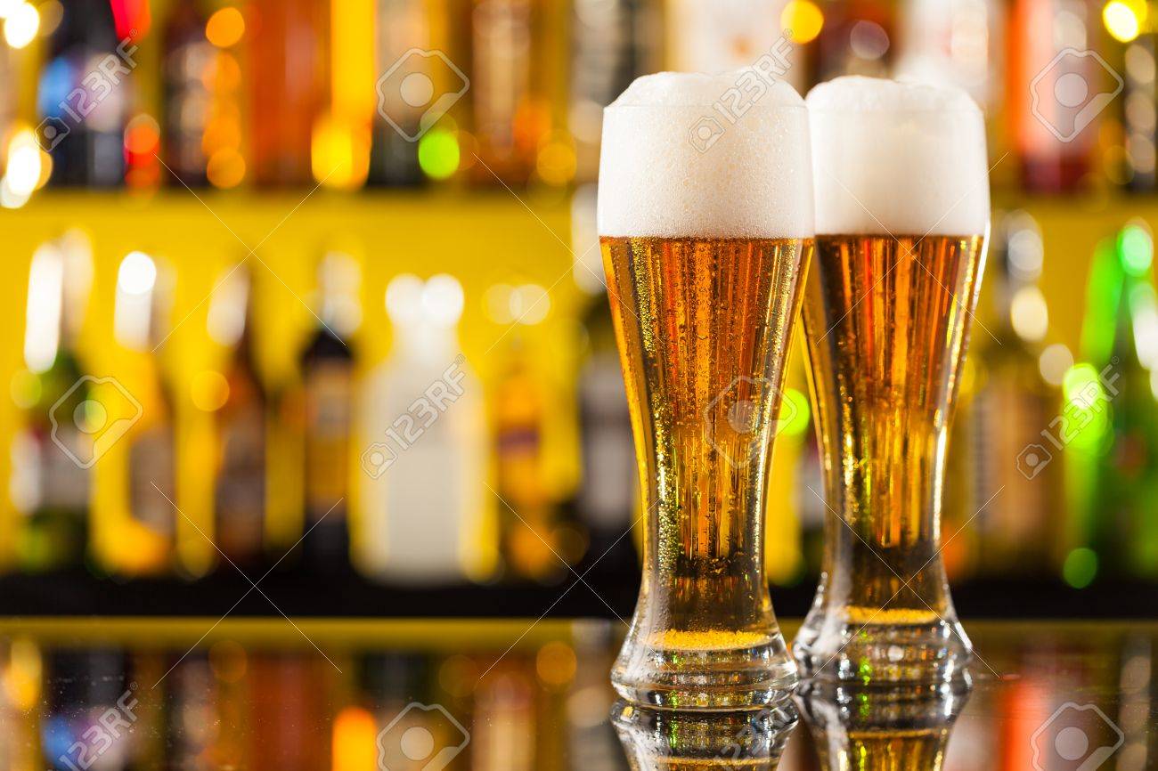 jugs of beer placed on bar counter with copyspace stock photo
