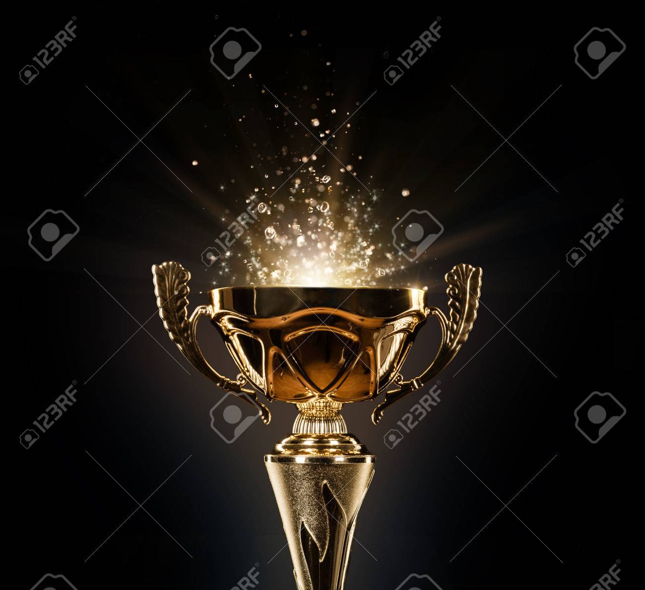 Champion golden trophy isolated on black background. Concept of success and achievement. - 73559722 Champion golden trophy isolated on black background. Concept of success and achievement. - 73559722