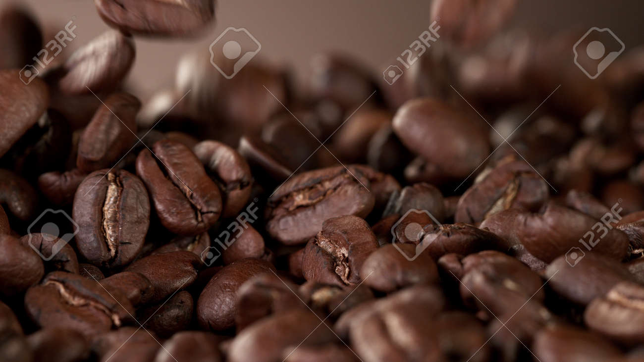 Pile of fresh roasted coffee beans with smoke around. Delicious coffee background - 168093356 Pile of fresh roasted coffee beans with smoke around. Delicious coffee background - 168093356