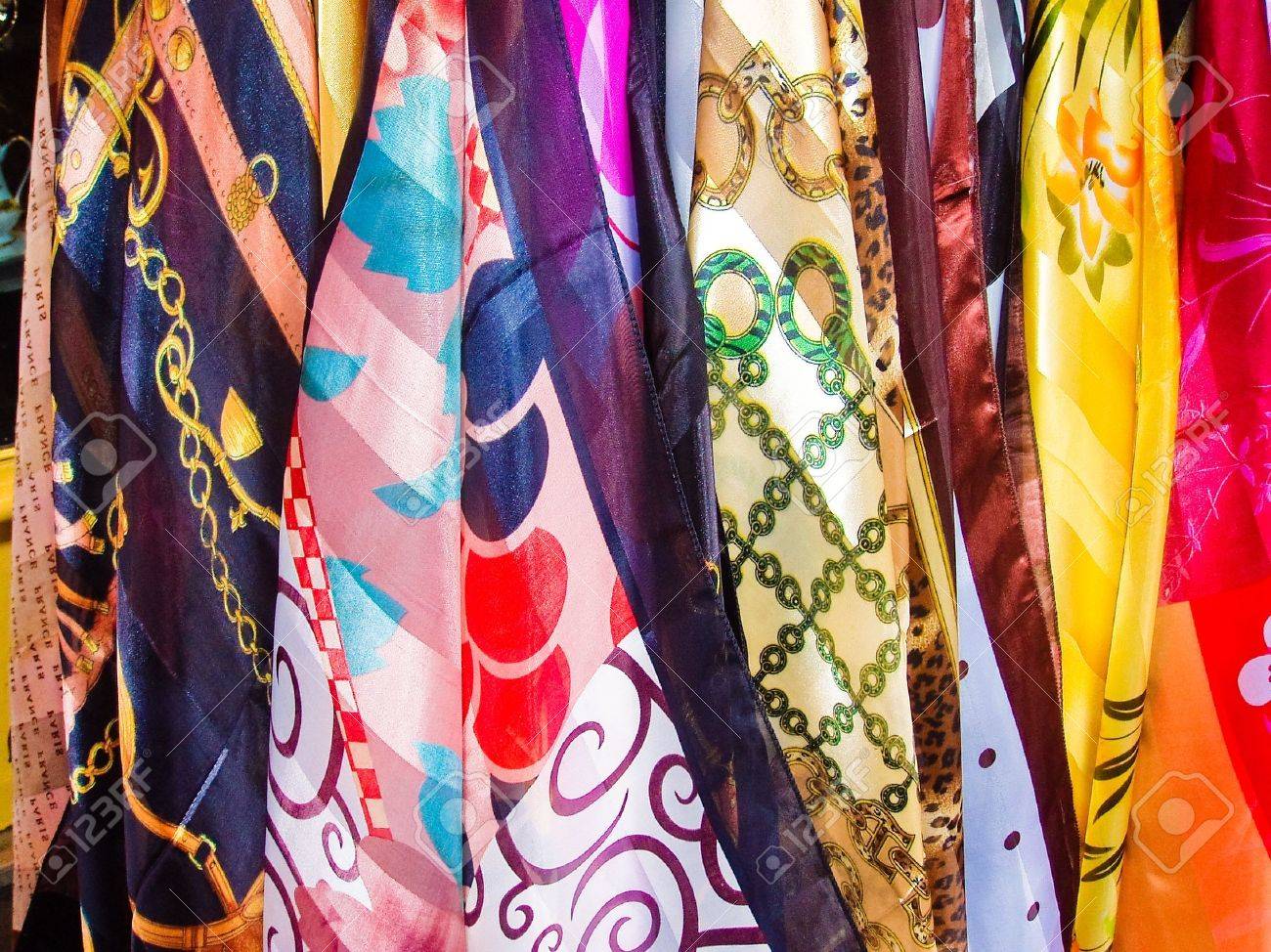 Variety of multicolored hanging scarves in Paris France - 5185821 Variety of multicolored hanging scarves in Paris France - 5185821
