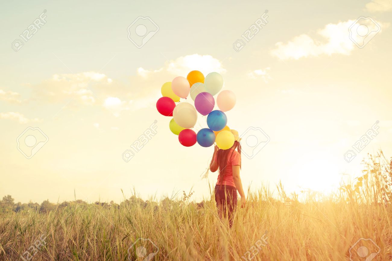 Happiness teen girl with colorful balloons enjoy in the sundown time at grassland. Happy birthday party. vintage color tone effect - 52070162 Happiness teen girl with colorful balloons enjoy in the sundown time at grassland. Happy birthday party. vintage color tone effect - 52070162