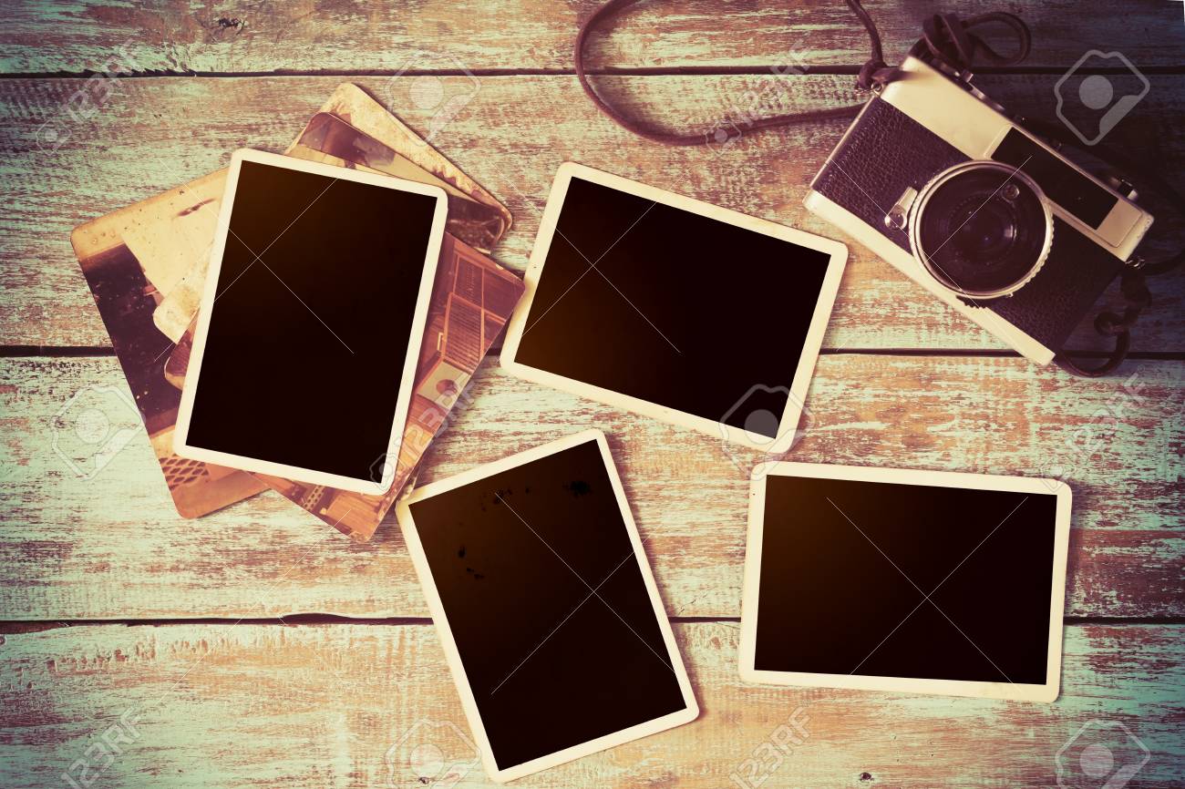 retro camera and empty old instant paper photo album on wood stock old style photo albums