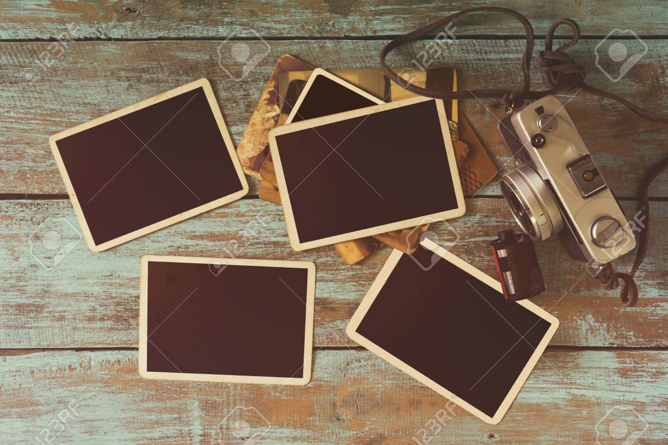 retro camera and empty old instant paper photo album on wood stock old style photo albums