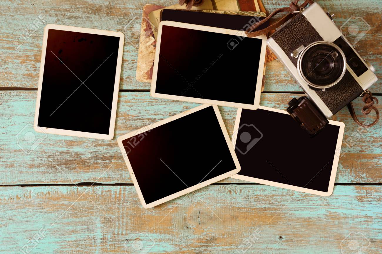 retro camera and empty old instant paper photo album on wood stock old style photo albums